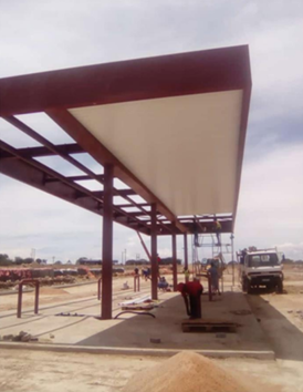 Puma Garage — Stella — Side canopy with roof sheeting underway