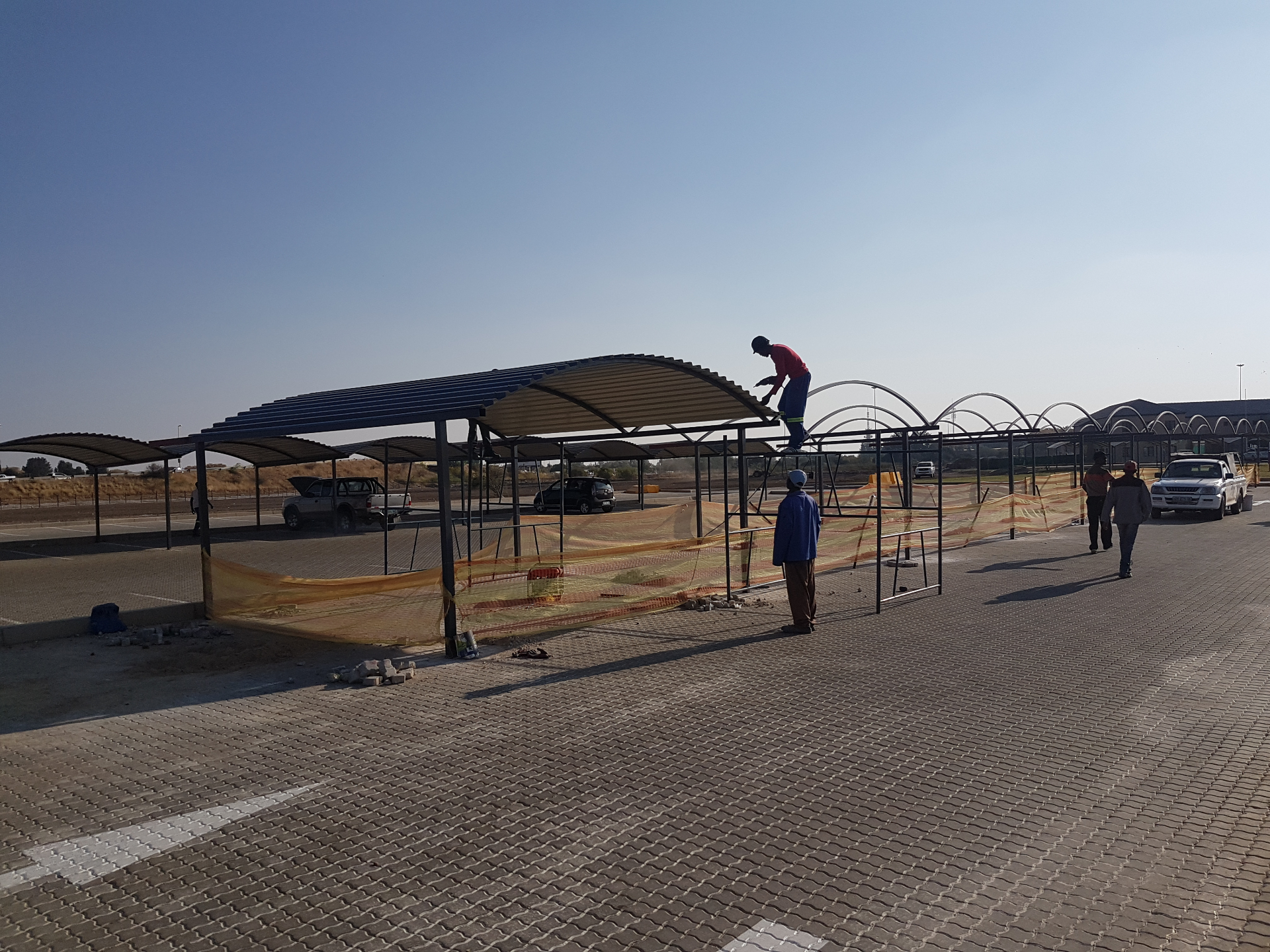 Curro Academy Carports — Installation in progress — roof sheeting underway