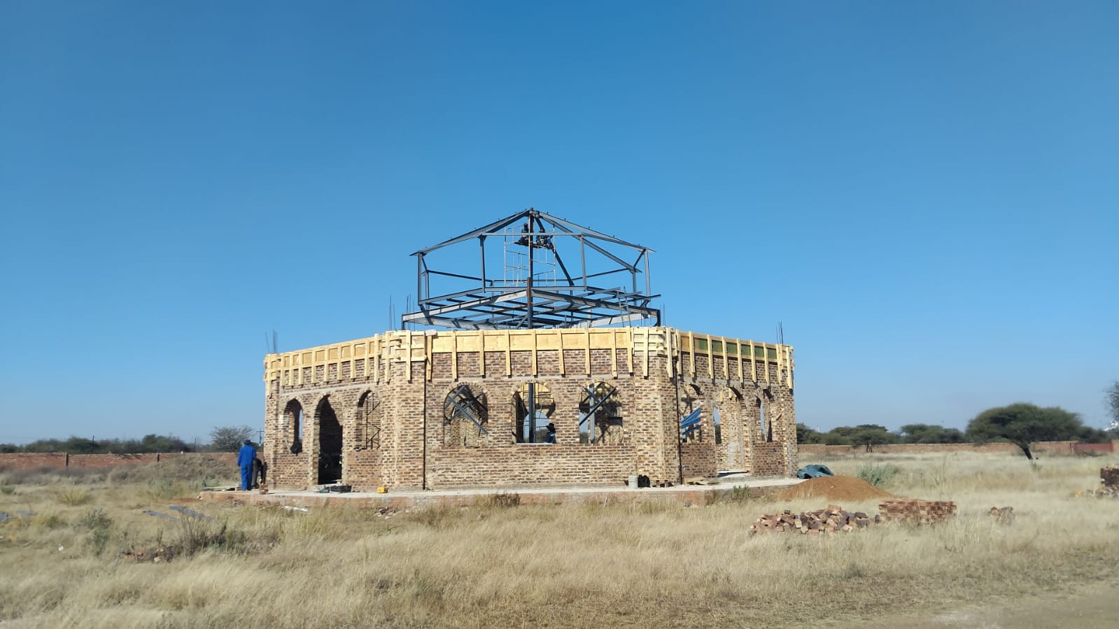 Saint Gabriel Church — Octagonal brick chapel with steel dome frame being installed