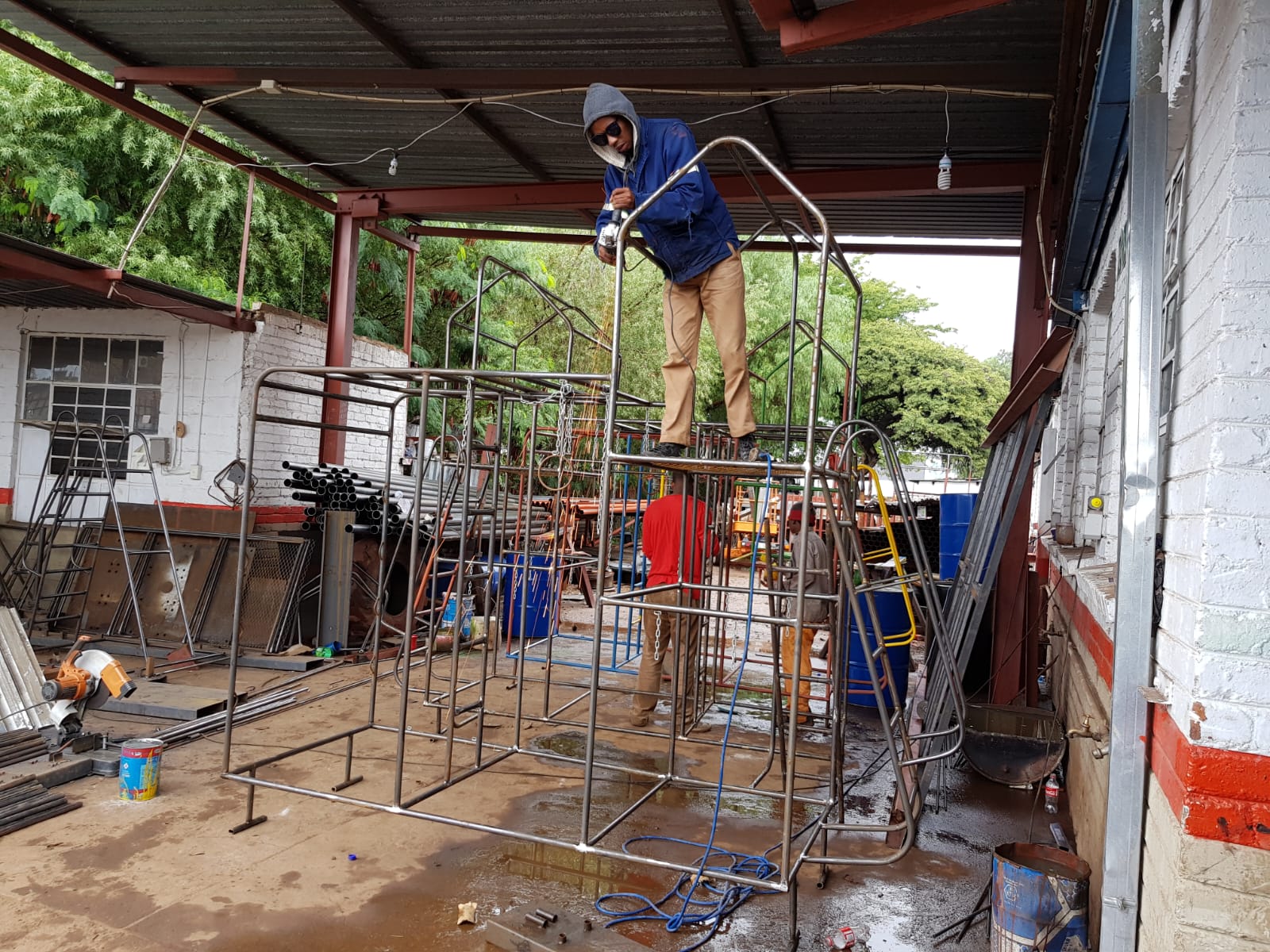 Jungle Gyms & Swings — Welding the canopy roof structure