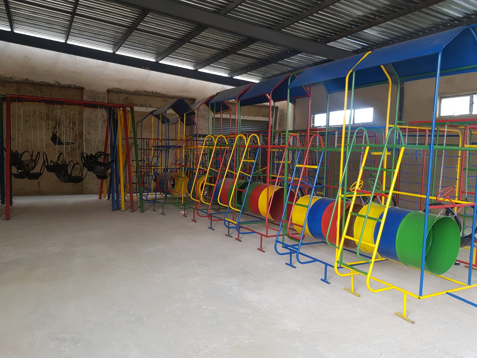 Jungle Gyms & Swings — Showroom line-up with tunnels & swings